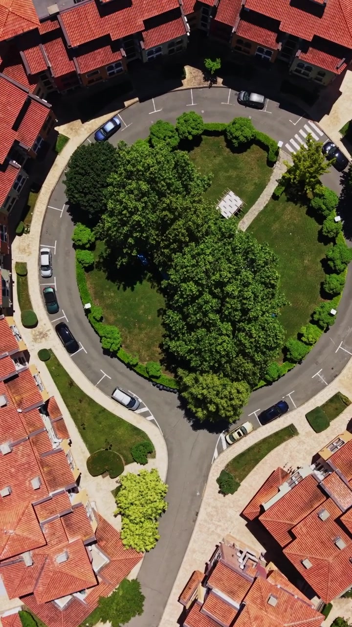 View of a building and pool area from above in a sunny location