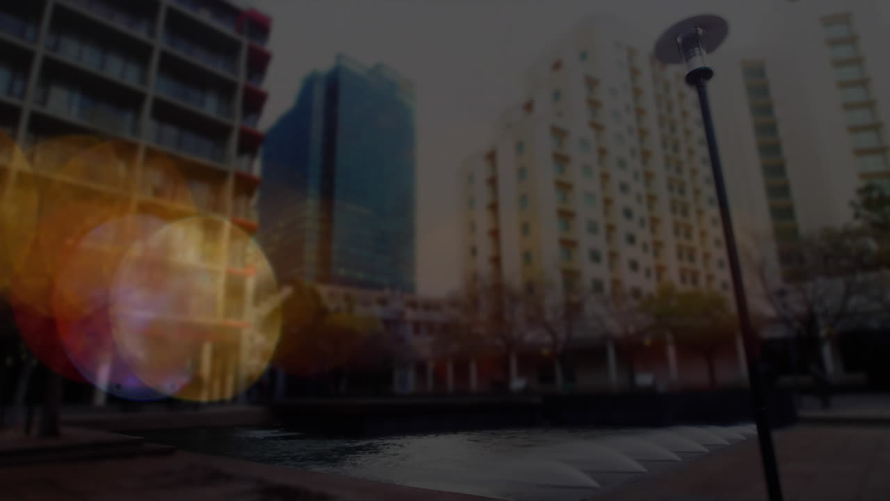 Animation of lens flares and graphs with numbers, time-lapse of people walking against buildings