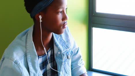 school girl using mobile phone in classroom