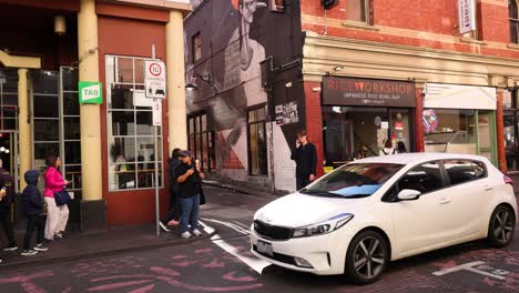 pedestrians and cars in chinatown, melbourne