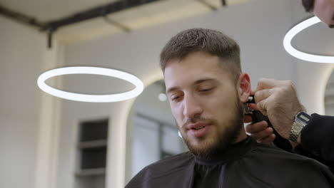 man getting a haircut at a barber shop