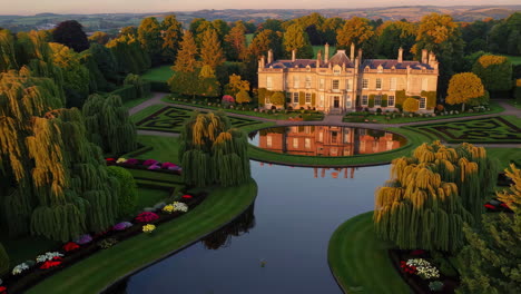beautiful english country house and gardens at sunrise