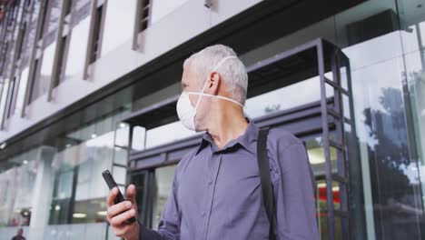 caucasian man out and about in the street wearing on a face mask against coronavirus