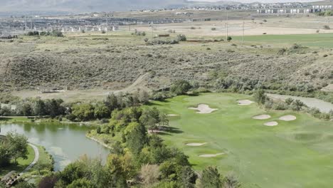 A-golf-course-in-a-desert-landscape---sliding-aerial-view