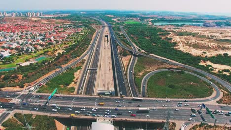 aerial of car driving on the highways and the city background in the left side