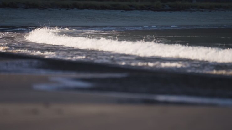 Waves roll slowly on the shallows of the sandy beach in Ersfjord-1
