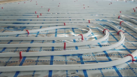 underfloor heating pipes are laid on a special surface installation of a heating system