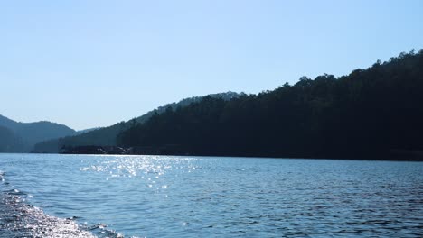 calm lake shimmering under clear blue skies