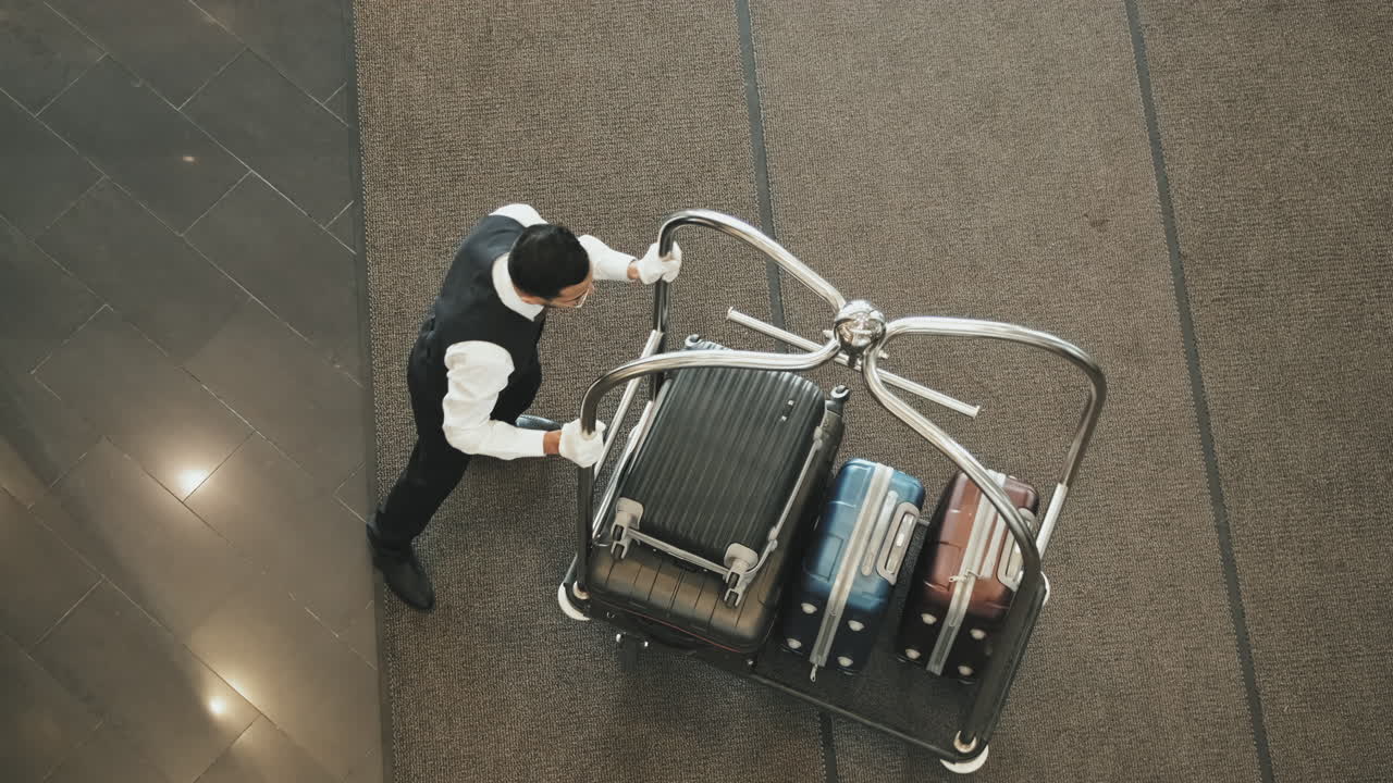 Tourists Giving their Luggage to Bellboy in Lobby