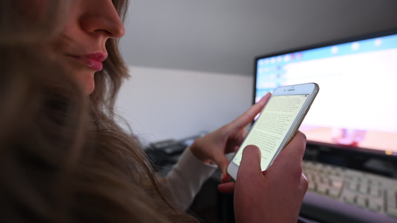CHISINAU, MOLDOVA - NOVEMBER, 2021: Woman working on white iphone at the office