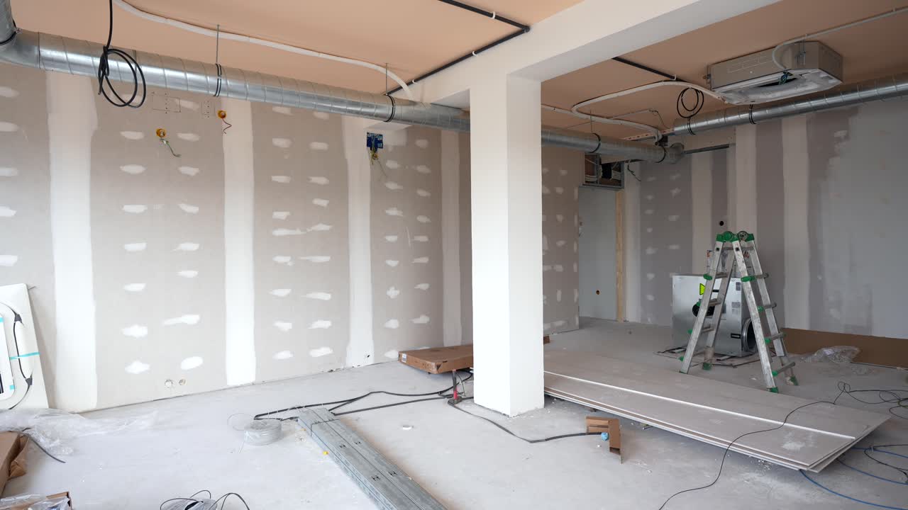 Empty Room Under Construction with Drywall and Exposed Ventilation System