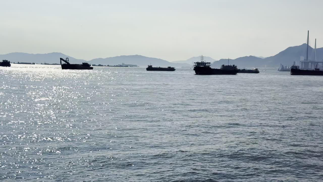 Footage of a vibrant blue sea filled with moving ships and ferries, capturing maritime transport, harbor activity, and scenic ocean views, perfect for travel, shipping, and coastal scenes