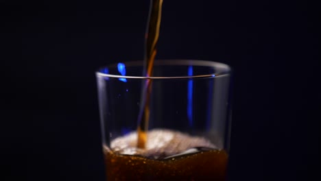 cold brew being poured into a tall pint glass