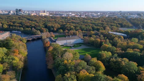schloss bellevue palace nestled among vibrant autumn foliage in tiergarten park, berlin, germany. marvelous aerial view flight speed ramp hyper motion time lapse