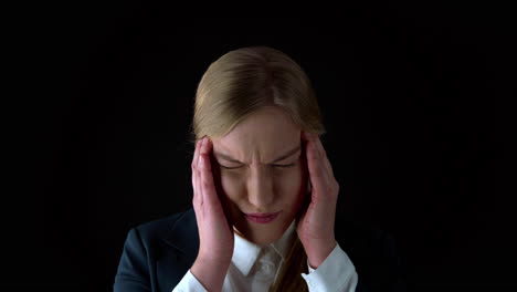 Close-up-potrait-of-young-woman-with-extreme-headache-press-head-with-finger