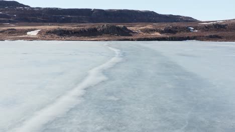 ice sheet on urriðavatn lake in east iceland, aerial