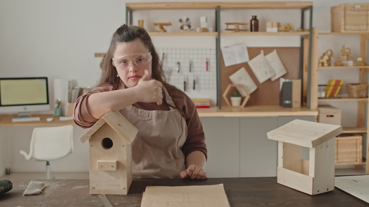 Woman with Down Syndrome Crafting Birdhouses in Workshop