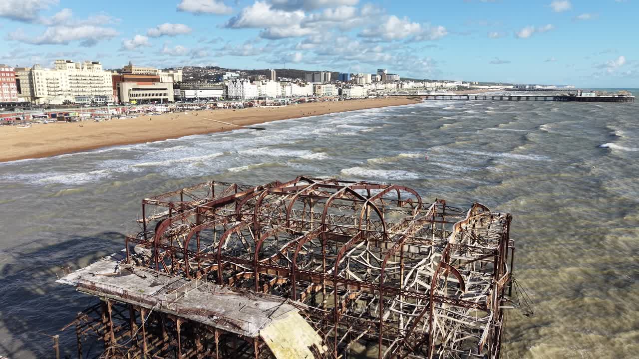 West Pier ruined pier in Brighton, UK pull back drone aerial reverse reveal