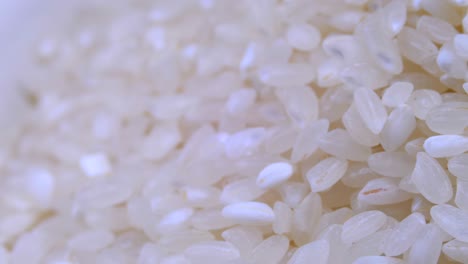 grains of raw rice rotate close-up