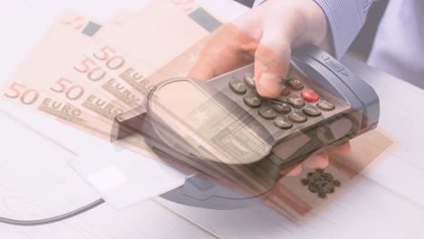 animation of euro banknotes falling over hand of caucasian man holding payment terminal