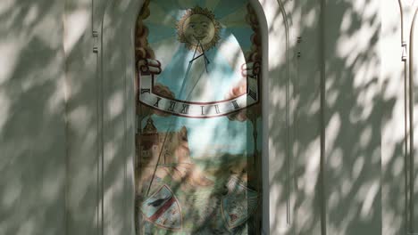artwork in the window of the facade of an old castle in zywiec - sundial