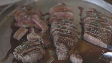 half-cooked veal on serving platter.  hd closed shot