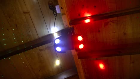 upward circling shot of colorful spotlights hanging from ceiling of establishment