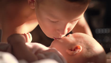 boy giving kiss to baby sister