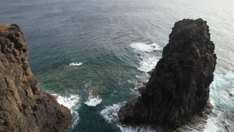 roque partido, gran canaria: fantastic aerial shot passing between the coast and the rock formation roque partido on the island of gran canaria and on a sunny day