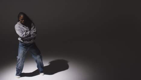 Full-Length-Studio-Portrait-Shot-Of-Young-Woman-Dancer-Dancing-In-Spotlight-With-Shadows-In-Foreground-2