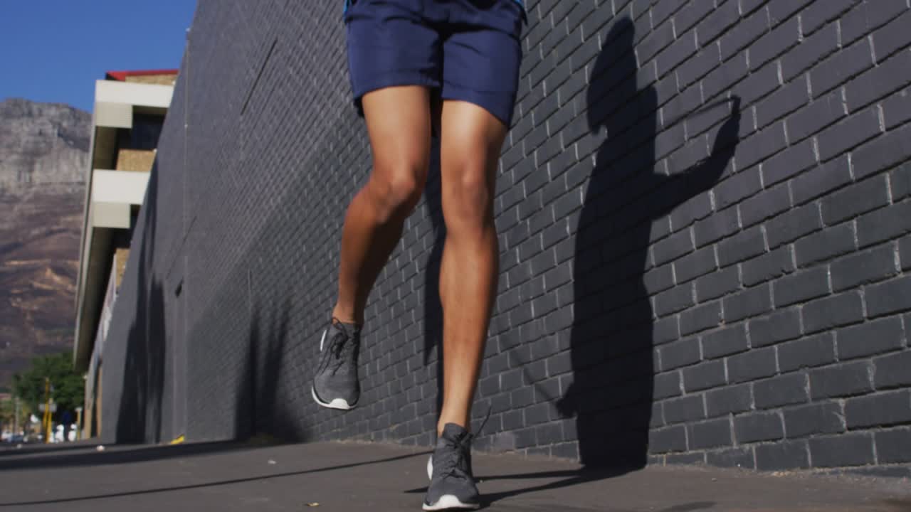 man skipping rope by brick wall for fitness promo, camera tilting revealing NEW SEASON turning gold