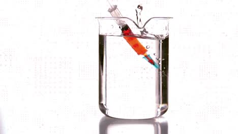 Animation-of-spots-over-beaker-with-liquid-and-syringe