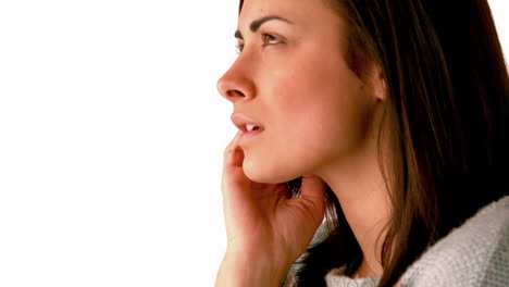 Upset-brunette-looking-up-on-white-background