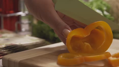 cutting an orange pepper