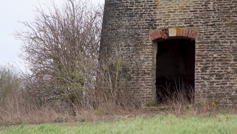 doorway to a disused and dilapidated windmill in the middle of a field in the village of north luffenham in the county of rutland, england