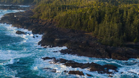 Drone-video-at-sunset-in-Ucluelet-British-Columbia,-Canada-over-the-ocean-and-forest