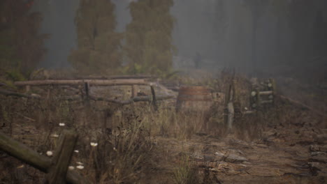 an old wood fence with a country field behind it