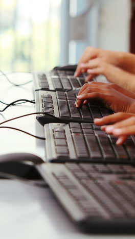 schoolgirls using computer in classroom