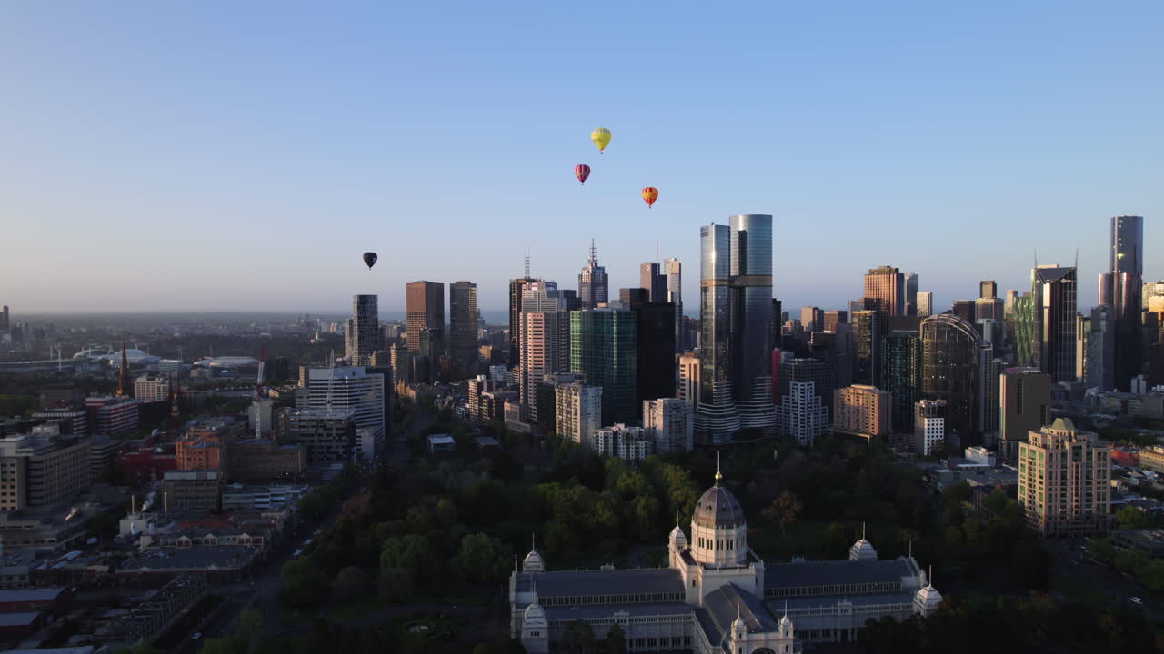 Aerial orbit shot sightseeing balloons above the city, golden hour Melbourne