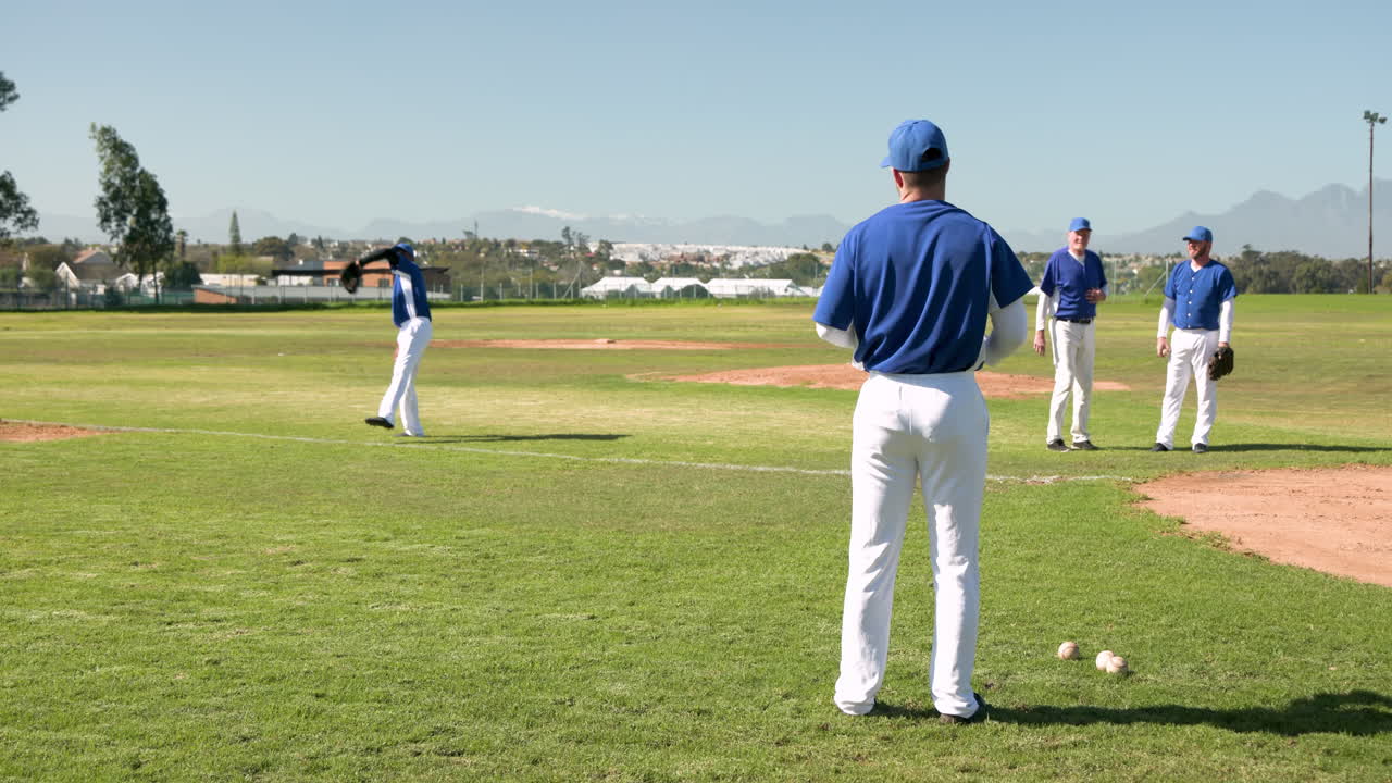 Playing baseball, male players practicing on field, throwing and catching balls