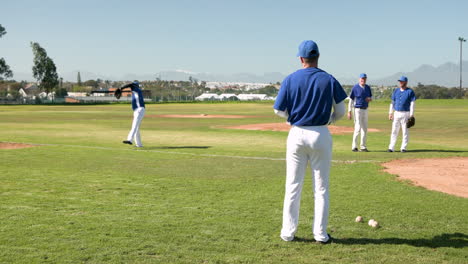 playing baseball, male players practicing on field, throwing and catching balls