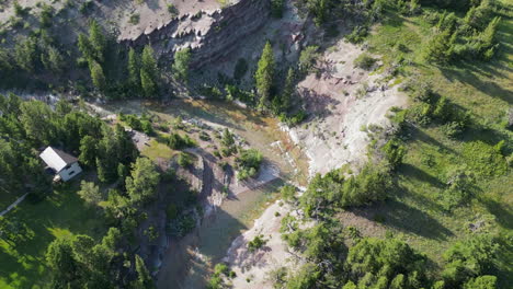 Immergrüne-Bäume-Werfen-Lange-Schatten-über-Die-Flussbiegung