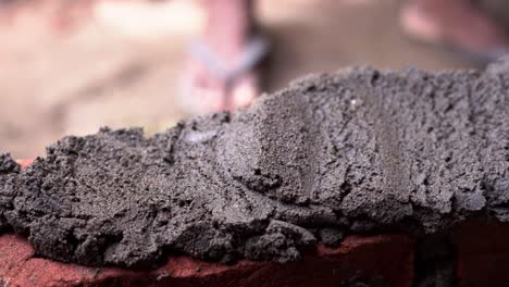 close up of brick in a building site while built house wall with concrete