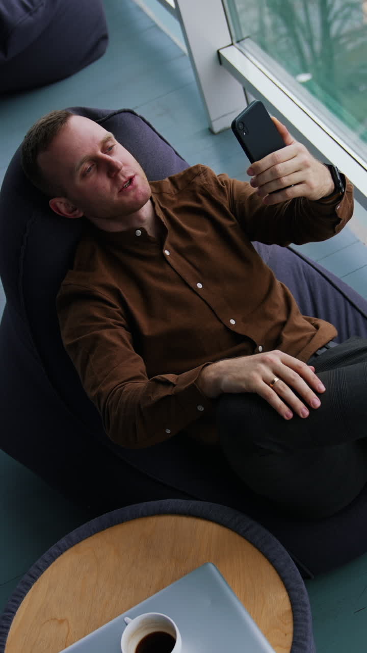 Happy businessman using mobile phone Vertical video