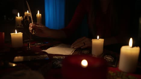 Woman practicing divination with tarot cards and candles