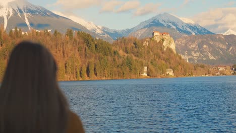 4K-video-of-a-beautiful-young-caucasian-female-looking-over-at-the-island-with-the-church-on-it