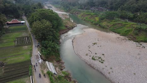 beautiful aerial view of a less water river in the middle of the mountains in the morning