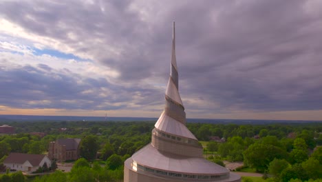 Slow-motion-of-the-spire-of-the-temple-at-sunset-in-Independence-Missouri-with-the-Church-of-Christ,-Community-of-Christ,-Remnant-and-The-Church-of-Jesus-Christ-of-Latter-day-Saints