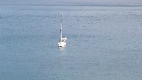 sailing at the tranquil ocean in baía de angra do heroísmo in terceira island, azores archipelago, portugal