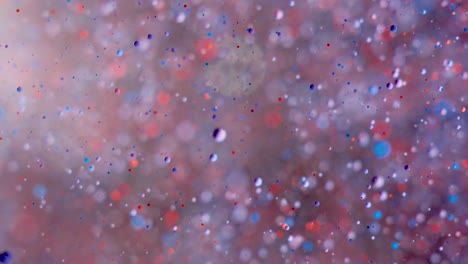 abstract chaotic motion of particles in space. slow motion bright colors bubbles oil paint universe moving multicolored close up. acrylic paint. fantastic hypnotic surface. big bang. nanotechnology.